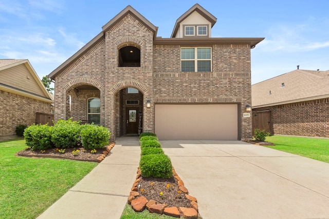 16875 Olympic National Dr, Humble, TX 77346 - view of front of house featuring brick siding, an attached garage, and concrete driveway