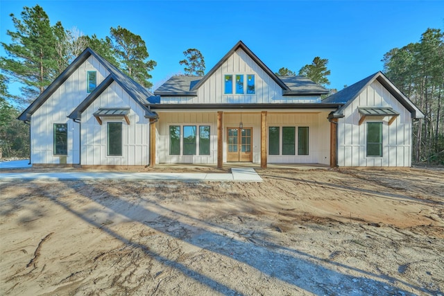 118 Ranger Rd, Huntsville, TX 77340 - modern farmhouse style home with covered porch, board and batten siding, french doors, and roof with shingles