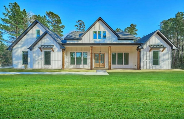 118 Ranger Rd, Huntsville, TX 77340 - view of front of house featuring board and batten siding, a front yard, and french doors