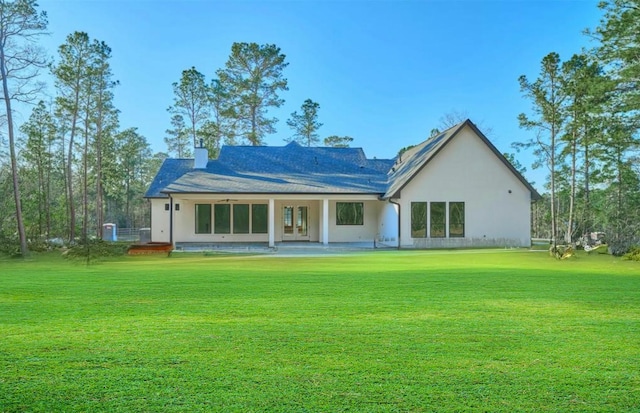 118 Ranger Rd, Huntsville, TX 77340 - back of property with french doors, a yard, stucco siding, and a chimney