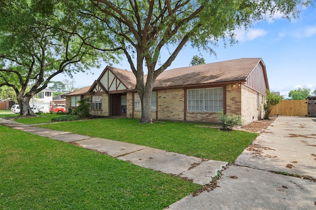 19207 Woodglen Dr, Katy, TX 77449 - view of front facade featuring brick siding, fence, a front lawn, and a gate