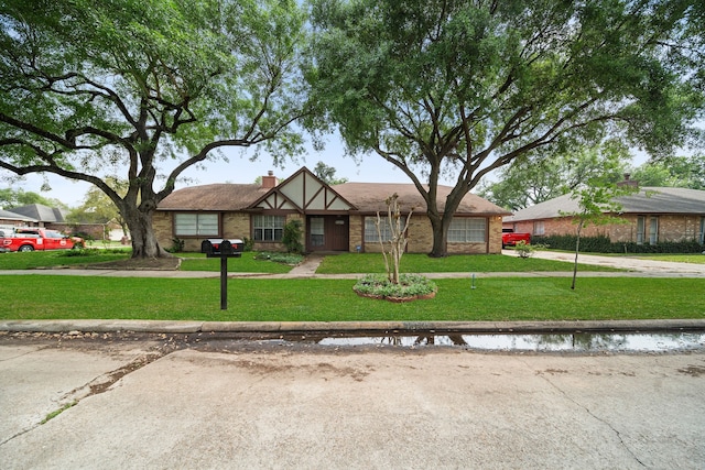 19207 Woodglen Dr, Katy, TX 77449 - view of front of home with a chimney and a front lawn
