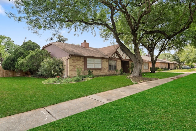 19207 Woodglen Dr, Katy, TX 77449 - view of front of property with a front lawn, a chimney, fence, and brick siding