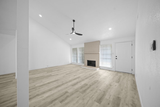 19207 Woodglen Dr, Katy, TX 77449 - unfurnished living room featuring lofted ceiling, recessed lighting, light wood-style floors, ceiling fan, and a fireplace