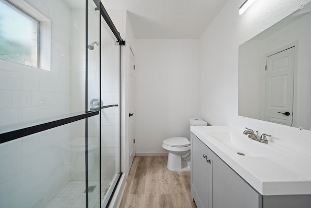 19207 Woodglen Dr, Katy, TX 77449 - full bathroom featuring a shower stall, toilet, wood finished floors, and vanity