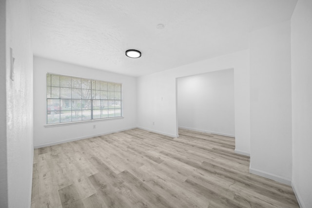 19207 Woodglen Dr, Katy, TX 77449 - unfurnished room with baseboards, wood finished floors, and a textured ceiling