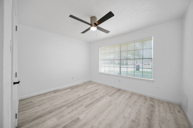 19207 Woodglen Dr, Katy, TX 77449 - spare room featuring baseboards, light wood-style floors, ceiling fan, and a textured ceiling