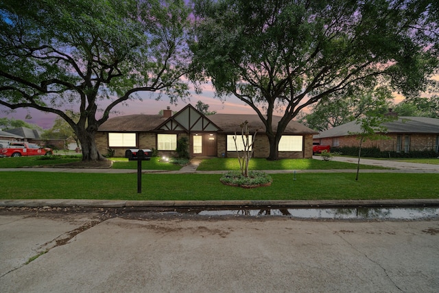 19207 Woodglen Dr, Katy, TX 77449 - tudor-style house featuring a garage and a yard