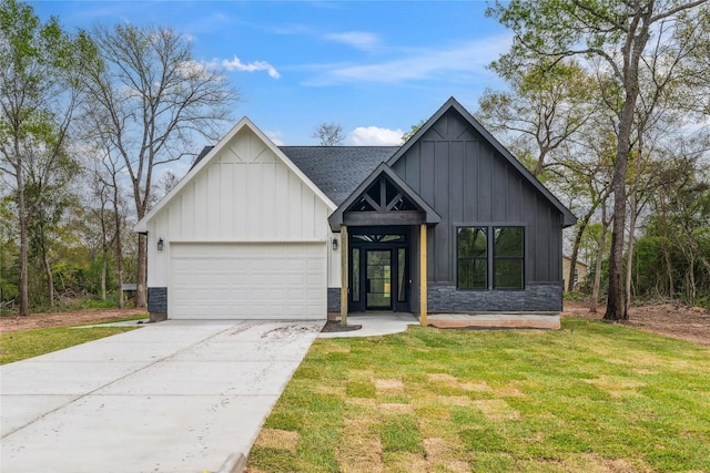 24717 Sligo St, Hempstead, TX 77445 - modern farmhouse with a front yard, stone siding, concrete driveway, an attached garage, and board and batten siding