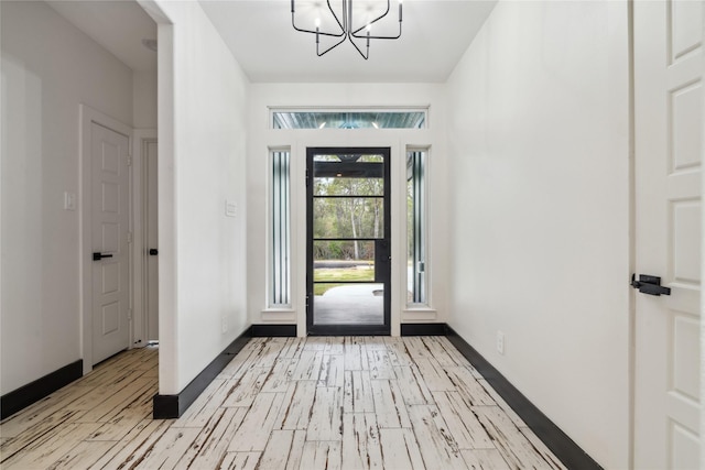 24717 Sligo St, Hempstead, TX 77445 - foyer with baseboards, light wood-style floors, and a chandelier