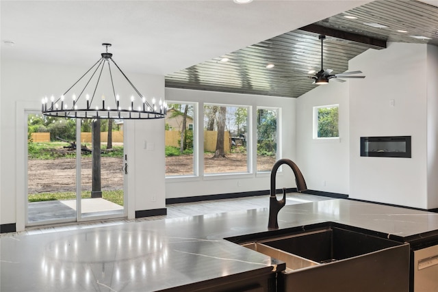 24717 Sligo St, Hempstead, TX 77445 - kitchen with a sink, pendant lighting, vaulted ceiling with beams, baseboards, and stainless steel counters