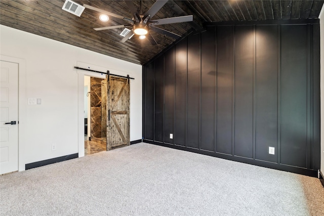 24717 Sligo St, Hempstead, TX 77445 - carpeted empty room featuring lofted ceiling, wood ceiling, a barn door, visible vents, and a ceiling fan