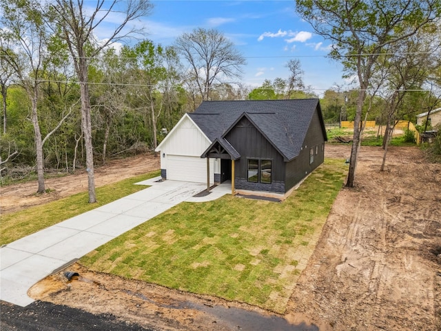 24717 Sligo St, Hempstead, TX 77445 - view of front of house featuring an attached garage, a front yard, concrete driveway, and roof with shingles