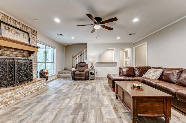 22814 Wren Ln, Tomball, TX 77377 - living room featuring stairway, light wood-style floors, ceiling fan, recessed lighting, and a stone fireplace