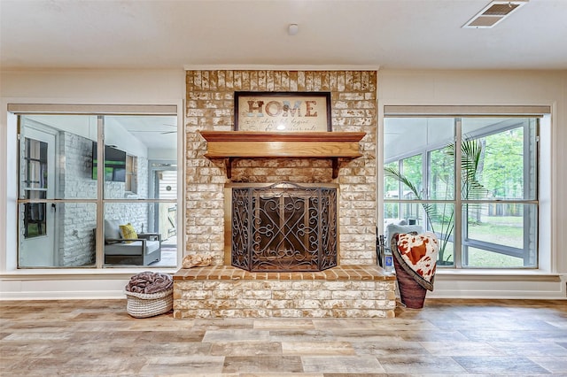 22814 Wren Ln, Tomball, TX 77377 - living area featuring a brick fireplace, baseboards, and wood finished floors