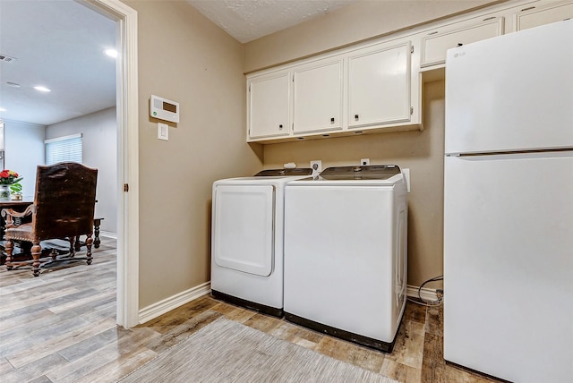 22814 Wren Ln, Tomball, TX 77377 - laundry room featuring cabinet space, washer and clothes dryer, light wood-style floors, baseboards, and recessed lighting