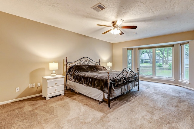 22814 Wren Ln, Tomball, TX 77377 - bedroom featuring light colored carpet, baseboards, a textured ceiling, and ceiling fan