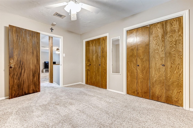22814 Wren Ln, Tomball, TX 77377 - unfurnished bedroom with multiple closets, carpet, baseboards, and a ceiling fan
