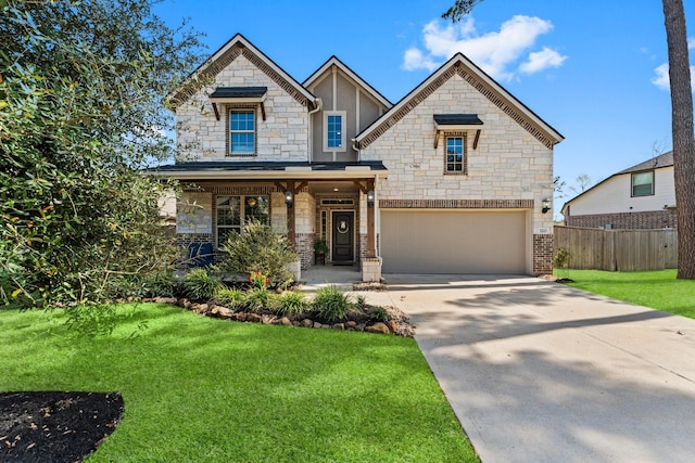 320 Cadela Dr, Montgomery, TX 77316 - view of front of property featuring stone siding, fence, an attached garage, a front yard, and driveway
