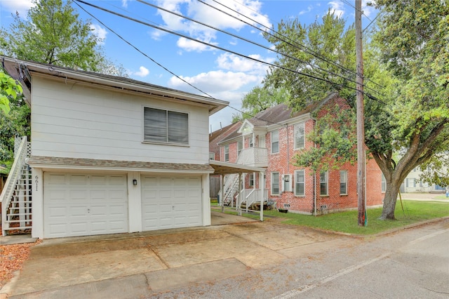 2348 Sheridan St, Houston, TX 77030 - view of front facade featuring an attached garage, concrete driveway, stairway, and brick siding