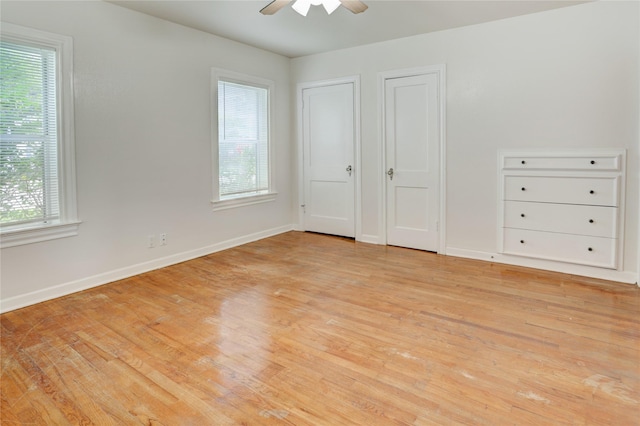 2348 Sheridan St, Houston, TX 77030 - unfurnished bedroom with light wood-type flooring, multiple windows, and baseboards