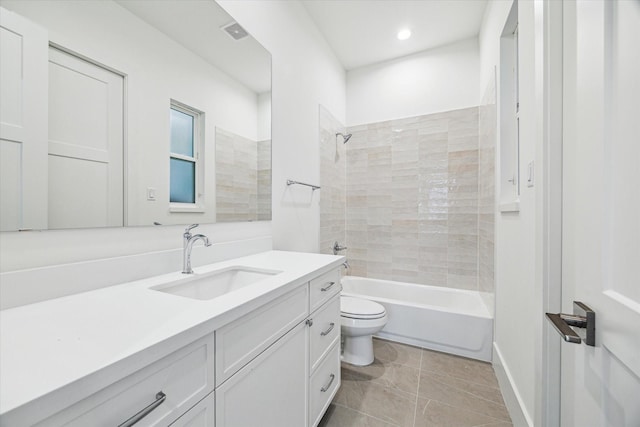 bathroom with tile patterned floors, toilet, vanity, visible vents, and tub / shower combination