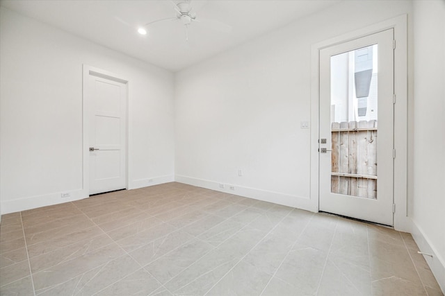 spare room featuring light tile patterned flooring, recessed lighting, a ceiling fan, and baseboards