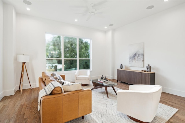 living room with baseboards, recessed lighting, a ceiling fan, and light wood-style floors