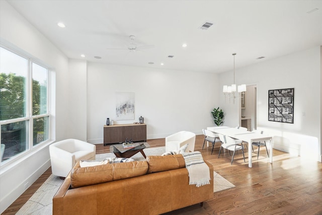 living room with wood finished floors, visible vents, recessed lighting, and baseboards