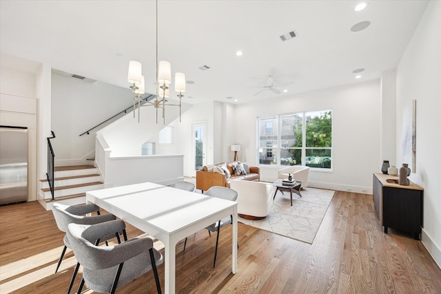 dining area featuring recessed lighting, stairs, visible vents, and light wood finished floors