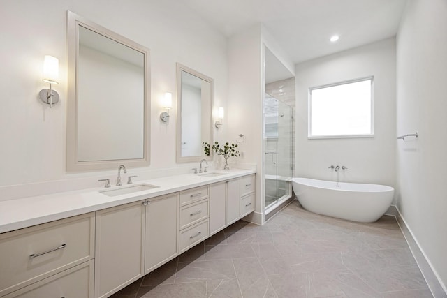 full bath with a freestanding tub, double vanity, a sink, and a shower stall