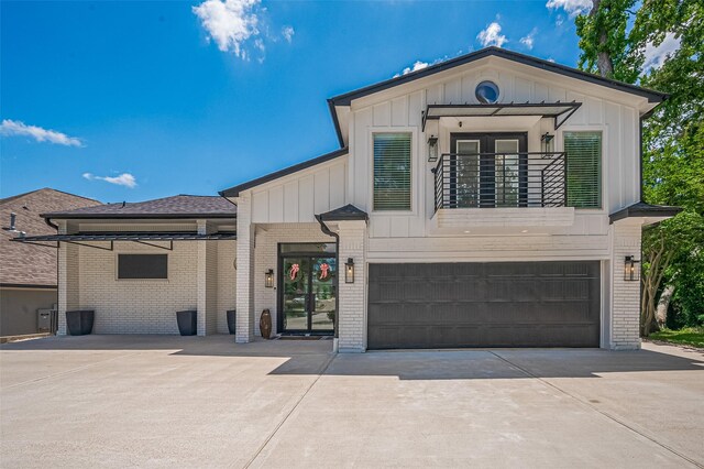 3734 Windswept Dr, Montgomery, TX 77356 - view of front of house with brick siding, board and batten siding, driveway, and an attached garage