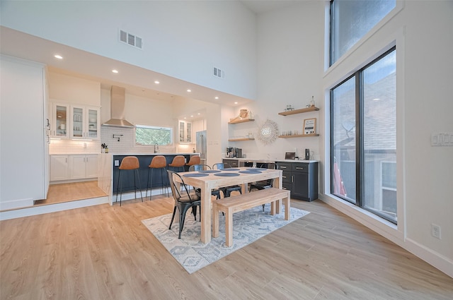3734 Windswept Dr, Montgomery, TX 77356 - dining room featuring light wood-type flooring, a high ceiling, recessed lighting, and baseboards