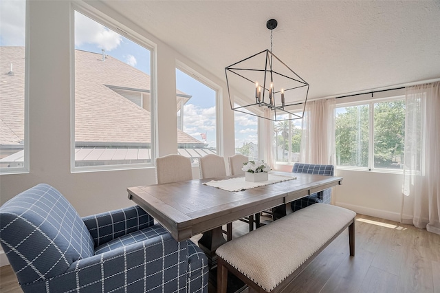 3734 Windswept Dr, Montgomery, TX 77356 - dining room featuring wood finished floors, a chandelier, and baseboards
