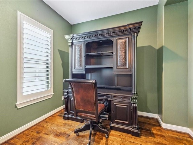 home office featuring baseboards and dark wood finished floors