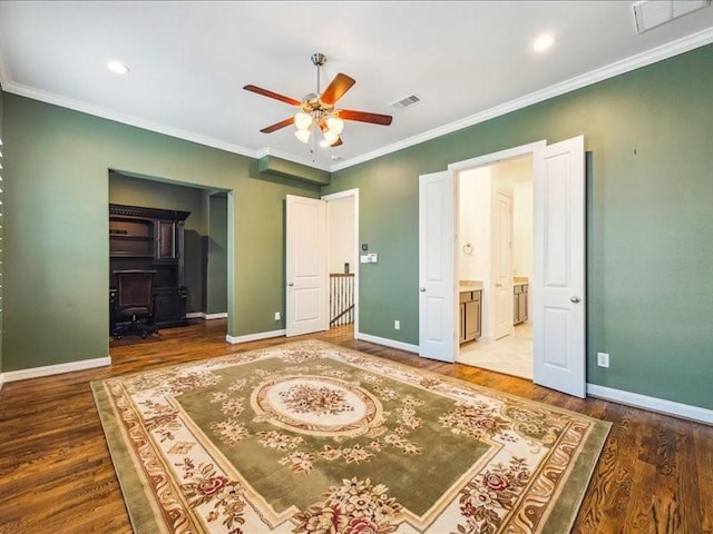 unfurnished bedroom featuring crown molding, wood finished floors, baseboards, and visible vents