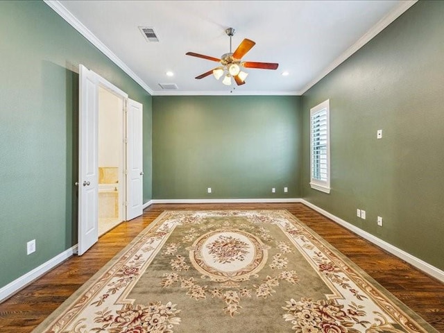 unfurnished bedroom featuring crown molding, wood finished floors, and baseboards