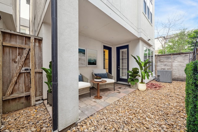 view of patio with cooling unit and fence