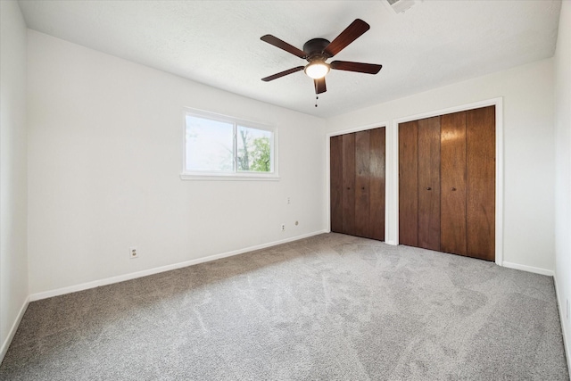 6106 Greenmont Dr, Houston, TX 77092 - unfurnished bedroom featuring multiple closets, carpet flooring, baseboards, and ceiling fan