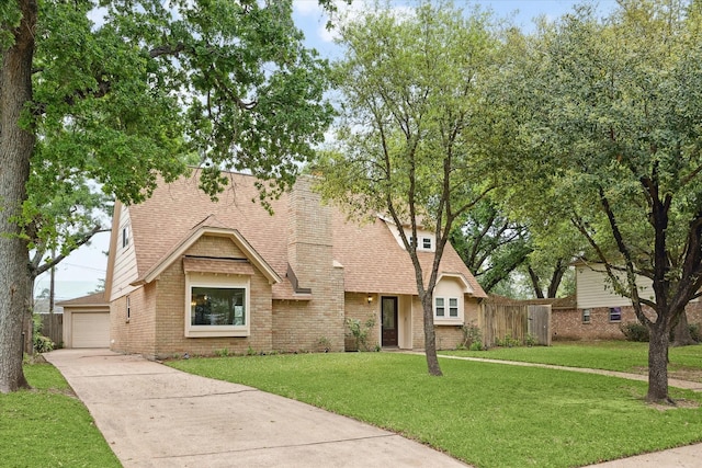 6106 Greenmont Dr, Houston, TX 77092 - view of front facade with a shingled roof, brick siding, and a detached garage