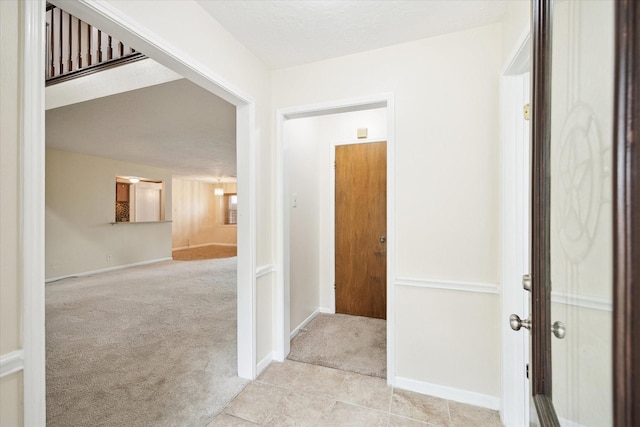 6106 Greenmont Dr, Houston, TX 77092 - hallway featuring carpet, baseboards, and tile patterned floors