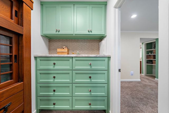 7575 Katy Fwy Unit 4, Houston, TX 77024 - kitchen featuring green cabinets, crown molding, baseboards, and carpet floors