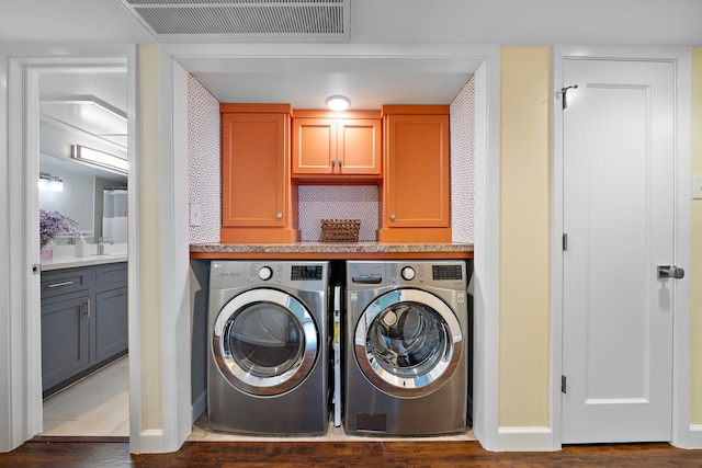 7575 Katy Fwy Unit 4, Houston, TX 77024 - laundry room with washing machine and clothes dryer, baseboards, and wood finished floors