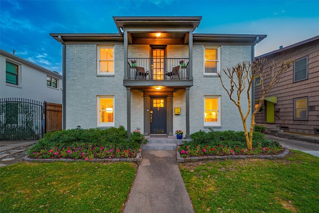 2311 Branard St, Houston, TX 77098 - traditional-style house featuring fence, a front lawn, a balcony, and brick siding