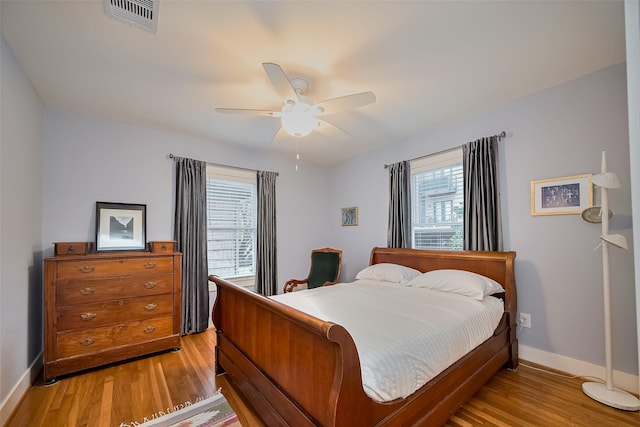 2311 Branard St, Houston, TX 77098 - bedroom with baseboards, light wood-style flooring, visible vents, and a ceiling fan