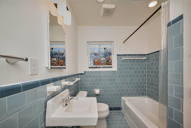 2311 Branard St, Houston, TX 77098 - bathroom with tile patterned floors, a sink, tile walls, a wainscoted wall, and toilet