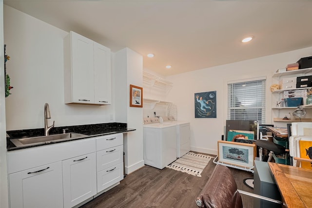 2311 Branard St, Houston, TX 77098 - clothes washing area with washer and clothes dryer, a sink, dark wood-style flooring, baseboards, and laundry area