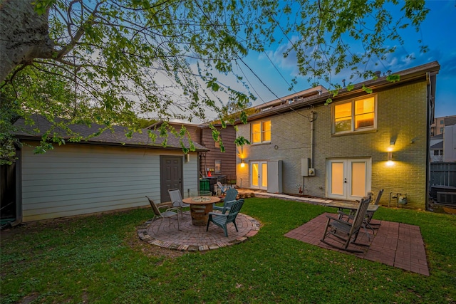 2311 Branard St, Houston, TX 77098 - back of property featuring a yard, a patio area, and an outdoor fire pit