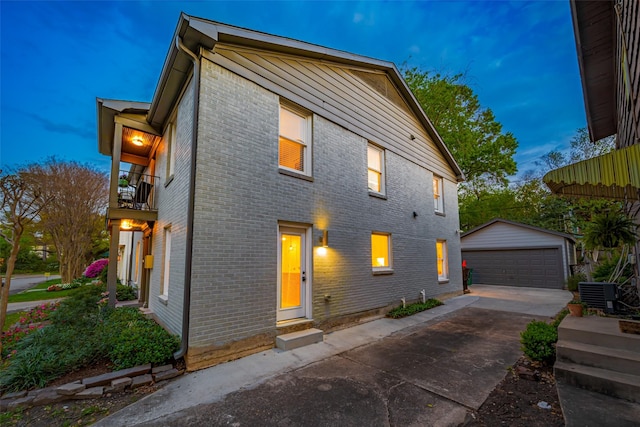 2311 Branard St, Houston, TX 77098 - view of front of property with a detached garage, central AC, brick siding, a balcony, and an outdoor structure