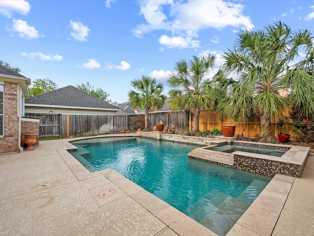 view of swimming pool with a fenced backyard, a patio, and a pool with connected hot tub